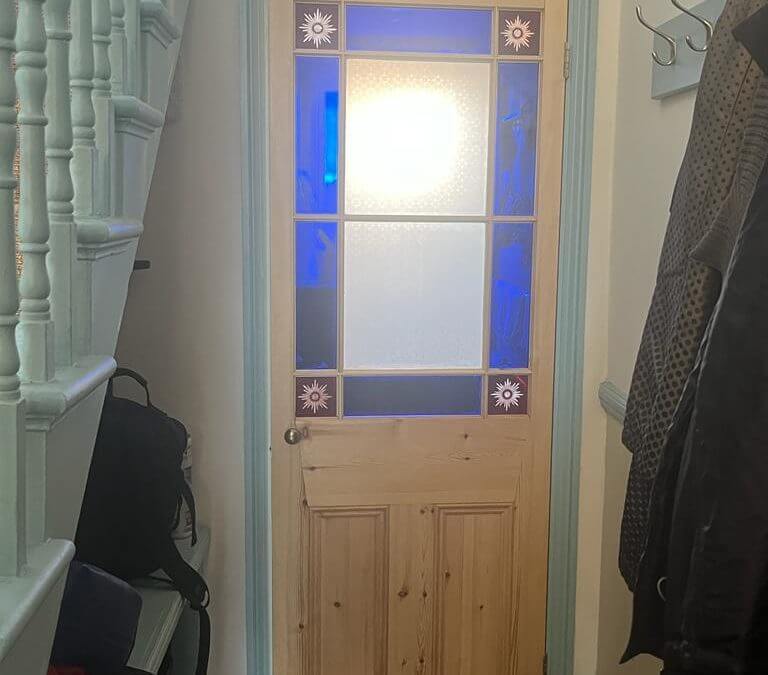 New timber door replaced with a stain glass window